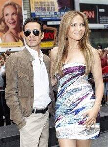 Jennifer Lopez poses with her husband Marc Anthony before an event unveiling the Boys and Girls Clubs of America's 'Be Extraordinary' billboard in TimesSquare.