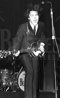 Twist and Shout - Animated stage shot of Paul, giving his all while playing his guitar and performing ‘Twist and Shout’