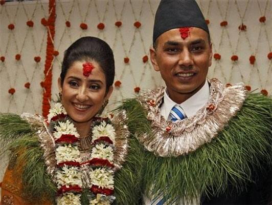 Bollywood  actress Manisha Koirala, left, poses for photographs with groom Samrat Dahal before getting married in Katmandu, Nepal, Friday, June 18, 2010.