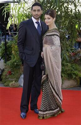 Indian actors Aishwarya Rai Bachchan, centre right, and husband Abhishek Bachchan arrive on the red carpet for the World Premiere of the film Raavan, at the BFI, British Film Institute, in London.