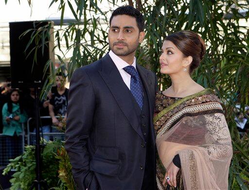 Indian actors Aishwarya Rai Bachchan, right, and husband Abhishek Bachchan arrive on the red carpet for the World Premiere of the film Raavan, at the BFI, British Film Institute, in London.