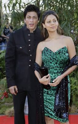 Indian actor Shahrukh Khan, left, and wife Gauri Khan arrive on the red carpet, for the World Premiere of the film Raavan, at the BFI, British Film Institute, in London.