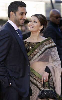 Indian actors Aishwarya Rai Bachchan, right, and husband Abhishek Bachchan arrive on the red carpet for the World Premiere of the film Raavan, at the BFI, British Film Institute, in London.