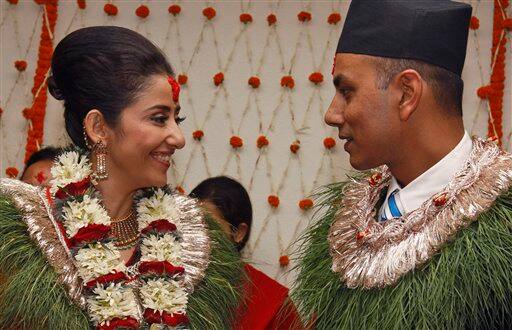 Bollywood actress Manisha Koirala, left, poses for photographs with groom Samrat Dahal before getting married in Katmandu, Nepal, Friday, June 18, 2010. Koirala's marriage ceremonies with Dahal, a Nepalese businessman, are spread over three days and will be attended by family and close friends.