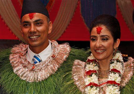 Bollywood actress Manisha Koirala, right, poses for photographs with groom Samrat Dahal before getting married in Katmandu, Nepal, Friday, June 18, 2010. Koirala's marriage ceremonies with Dahal, a Nepalese businessman, are spread over three days and will be attended by family and close friends. 