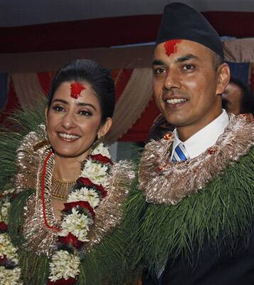 Bollywood actress Manisha Koirala, left, poses for photographs with the groom Samrat Dahal before getting married in Katmandu, Nepal, Friday, June 18, 2010. Koirala married Nepalese businessman Dahal in a traditional ceremony Friday attended by family and close friends.