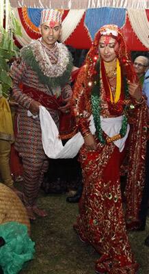 Bollywood actress Manisha Koirala, right, and groom Samrat Dahal perform rituals at a resort, just outside Katmandu, Nepal, Saturday, June 19, 2010. Koirala married Nepalese businessman Dahal in a traditional ceremony attended by family and close friends.