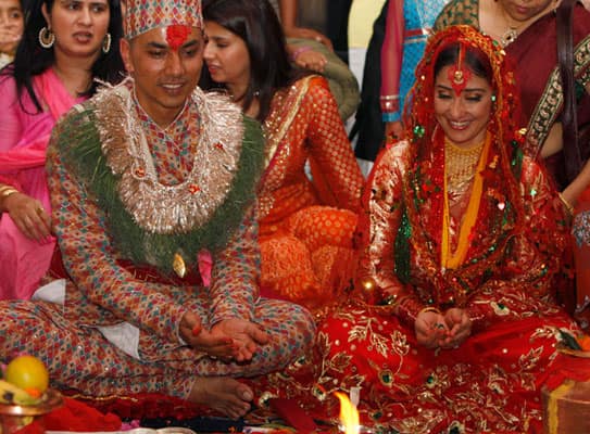 Manisha Koirala, right, and groom Samrat Dahal perform rituals at a resort just outside Katmandu, Nepal. 