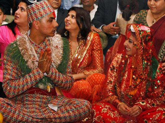 Manisha Koirala, right, and groom Samrat Dahal perform rituals at a resort just outside Katmandu, Nepal. 