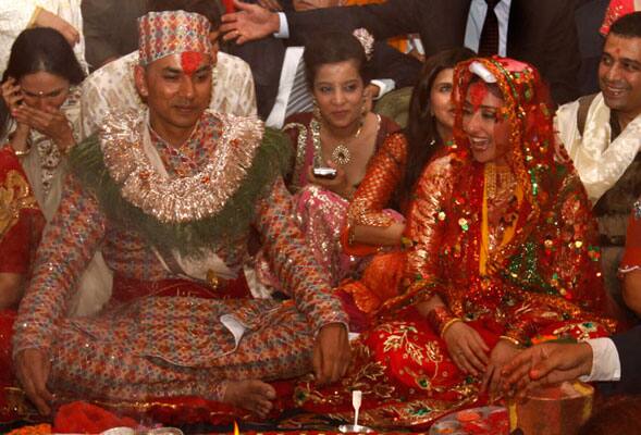 Manisha Koirala, right, and groom Samrat Dahal perform rituals at a resort just outside Katmandu, Nepal. 