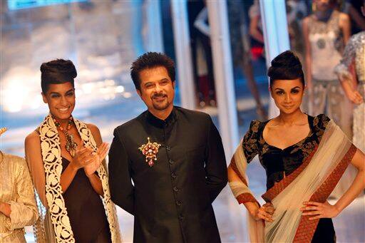 Bollywood actor Anil Kapoor, center, and models display creations by Indian designer Anamika Khanna at the Pearls Infrastructure Delhi Couture Week 2010 in New Delhi, India.