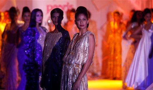 Models present creations by designers Abu Jani & Sandeep Khosla at the Pearls Infrastructure Delhi Couture Week 2010 in New Delhi, India.