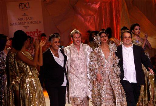 Indian designers Abu Jani, second left, & Sandeep Khosla, right, walk the ramp with Australian cricketer Brett Lee, center, and socialite Shweta Nanda at the Pearls Infrastructure Delhi Couture Week 2010 in New Delhi, India.