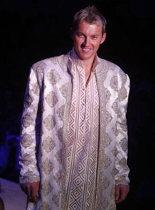 Australian cricketer Brett Lee presents a creation by designers Abu Jani & Sandeep Khosla at the Pearls Infrastructure Delhi Couture Week 2010 in New Delhi, India.