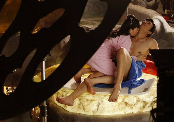 Japanese adult actress Saori Hara (L) and actor Hayama Hiro rehearse an erotic scene during the making of 