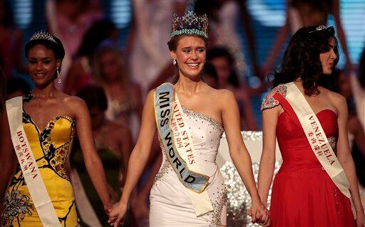 Alexandria Mills of U.S.A., center, holds hands with Miss Botswana Emma Wareus, left, and Miss Venezuela Adriana Vasini, after crowned as winner of the 2010 Miss World pageant contest at the Beauty Crown Cultural Center in Sanya.