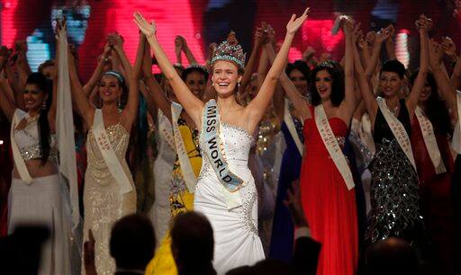 Miss USA Alexandria Mills, front center, gestures with other contestants after being crowned the winner of the 2010 Miss World pageant contest at the Beauty Crown Cultural Center in Sanya.