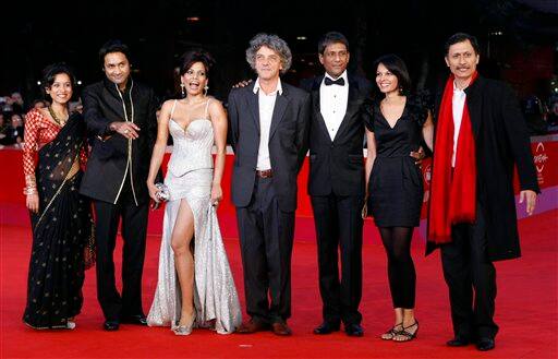 From left, actress Tillotama Shome, actor Samrat Chakrabarti, actress Priyanka Bose, director Italo Spinelli, actor Adil Hussain, actress Seema Rahmani and actor Dibang pose as they arrive on the red carpet of their movie 