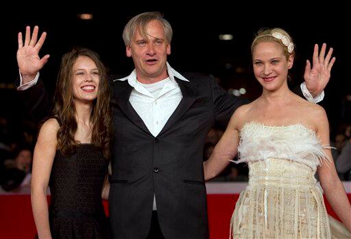 Director Chris Kraus, center, poses with actresses Paula Beer, left, and Jeannette Hain as they arrive on the red carpet to attend the screening of their movie 