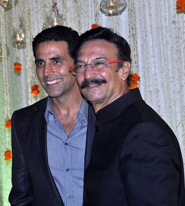 Indian Bollywood actors Akshay Kumar (L) and Suresh Oberoi poses together at newly wed Vivek Oberoi and Priyanka Alva's reception party in Mumbai.