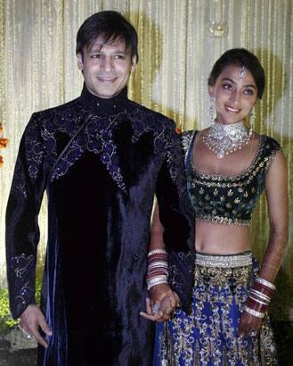 Indian Bollywood actor Vivek Oberoi (L) recently married Priyanka Alva (R) pose at a reception party in Mumbai.