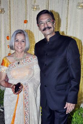 Indian Bollywood actor Suresh Oberoi (R) poses with his wife at their son's Vivek Oberoi and newly wed wife Priyanka Alva reception party in Mumbai.