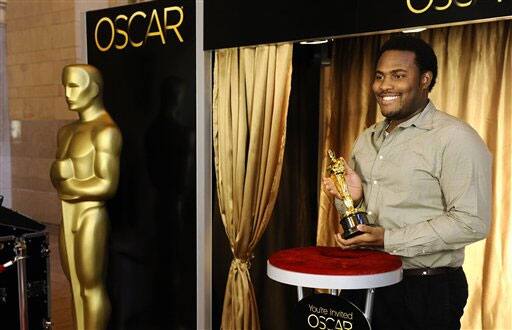 Seni Oyewole from Nigeria, poses with an Oscar statuette at the ribbon cutting of the 'Meet The Oscars' event at Grand Central Station in New York.