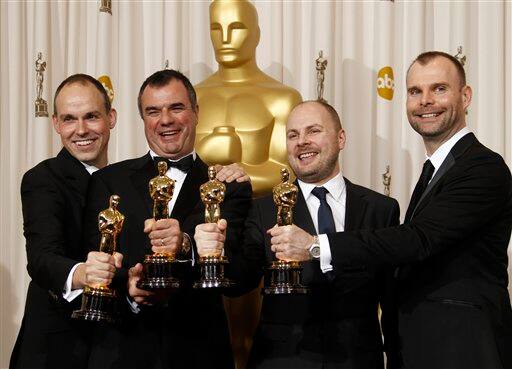 Paul Franklin, left, Chris Corbould, second from left, Andrew Lockley, second from right, and Peter Bebb pose backstage with the Oscar for best visual effects for 