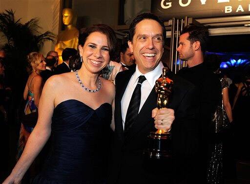 Director Lee Unkrich holds up his oscar for best picture while attending the Governors Ball with guest following the 83rd Academy Awards.