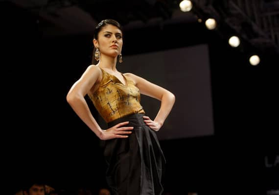 An Indian model displays designer Lina Tipnis creations during the Lakme Fashion Week in Mumbai.