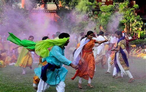 Students of Rabindra Bharati University, faces smeared with colored powder, dance during Holi festival celebrations at the residence of India's first Nobel laureate Rabindranath Tagore in Calcutta.