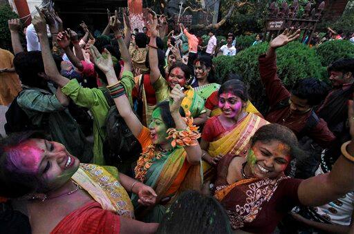 Students of Rabindra Bharati University, faces smeared with colored powder, dance during Holi festival celebrations at the residence of India's first Nobel laureate Rabindranath Tagore in Calcutta.