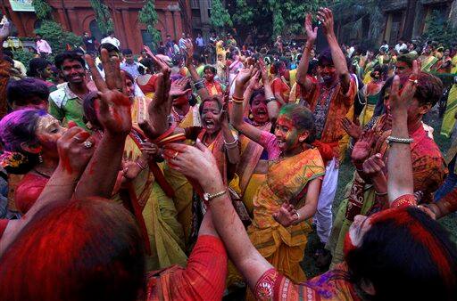 Students of Rabindra Bharati University, faces smeared with colored powder, dance during Holi festival celebrations at the residence of India's first Nobel laureate Rabindranath Tagore in Calcutta.