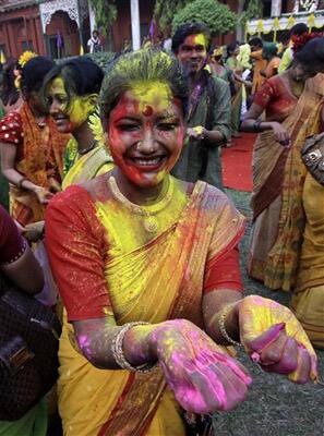 A student of Rabindra Bharati University, face smeared with colored powder, participates in Holi festival celebrations at the residence of India's first Nobel laureate Rabindranath Tagore in Calcutta.