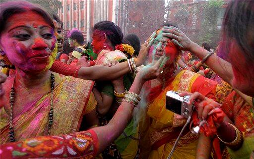 Students of Rabindra Bharati University smear the face of a fellow student with colored powder during Holi festival celebrations at the residence of India's first Nobel laureate Rabindranath Tagore in Calcutta.