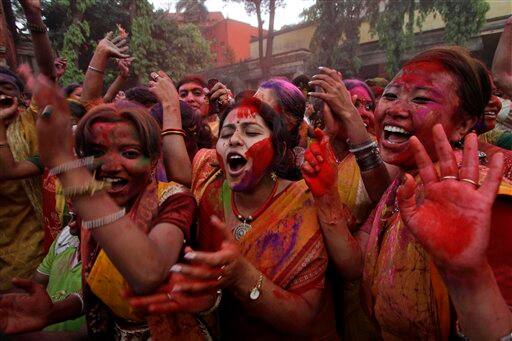 Students of Rabindra Bharati University, faces smeared with colored powder, dance during Holi festival celebrations at the residence of India's first Nobel laureate Rabindranath Tagore in Calcutta.