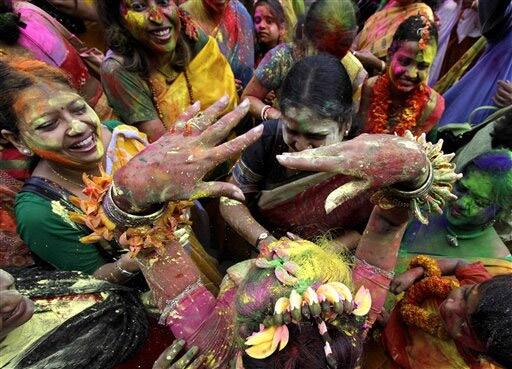 Indian women play with colored powder during festivities marking holi in Calcutta.