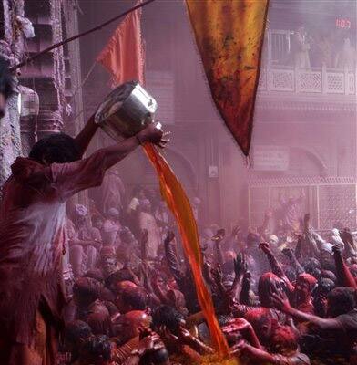 Hindu devotees colored by powder thrown while celebrating 