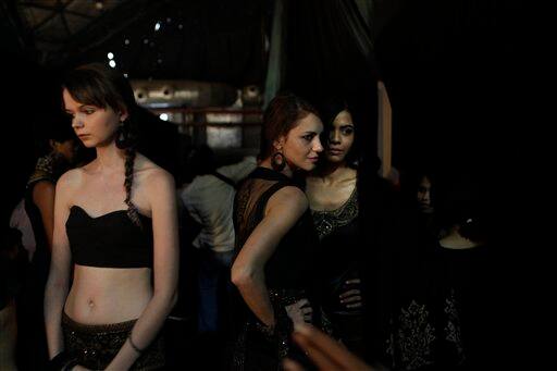 Models wait backstage before a show during the Wills Life Style India Fashion Week, in New Delhi.