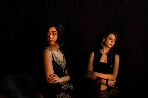 Models wait backstage before going on the catwalk during the Wills Lifestyle India Fashion week, in New Delhi.