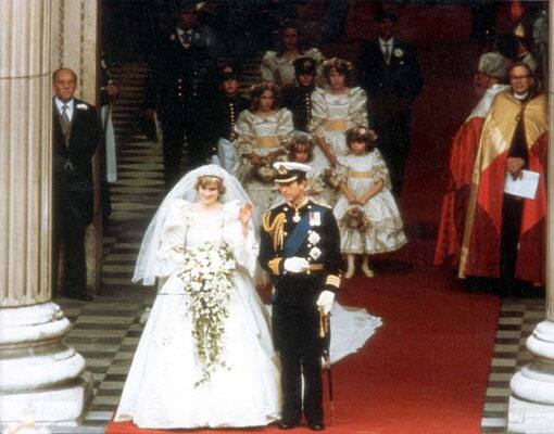 Princess Diana's gown train flows elegantly as she walks.