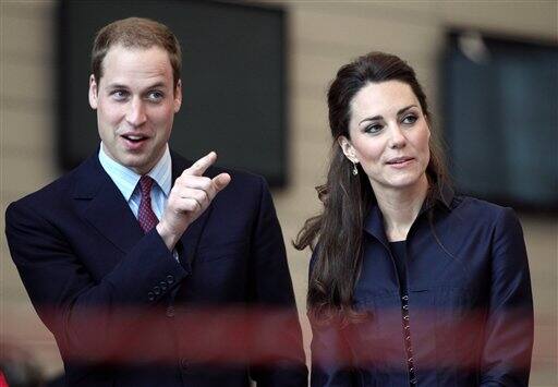 Britain's Prince William and his fiancee Kate Middleton watch a demonstration by students.