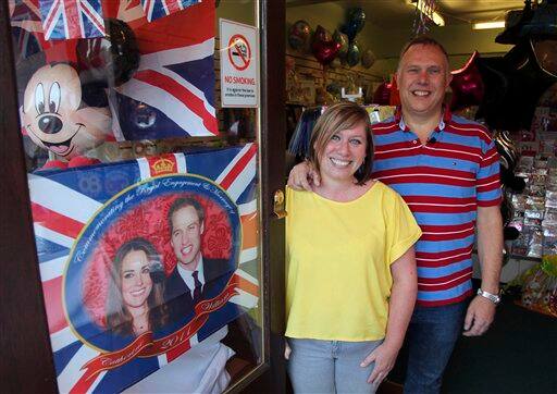 Chris Davis and his bride to be Pam Young stand inside their party supply store, in Hornchurch, England, Saturday, April 23, 2011. Davis and Young will marry on Friday April 29 , the same day as Britain's Prince William and Katherine Middleton.