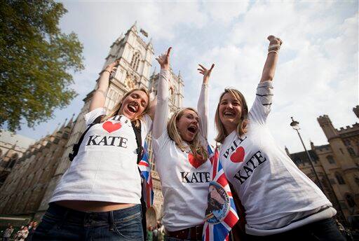 Royal fans cheer in front of Westminster Abbey in London, Tuesday, April 26, 2011. Revelers are camping out outside the Abbey where Prince William and Kate Middleton are due to get married.