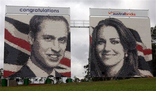 Two 100 foot mosaic brick walls of Britain's Prince William and Kate Middleton stand in a open field beside a busy express-way in Sydney, Australia.