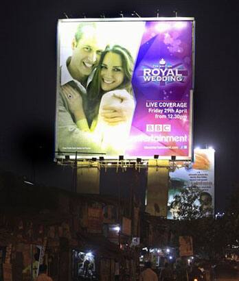 Traffic moves past a giant hoarding advertising the royal wedding of Britain's Prince William and Kate Middleton, in Mumbai.