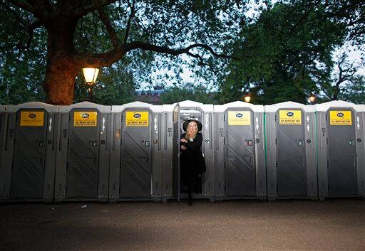 Jordan Lee from Jackson Mississippi emerges from a temporary lavatory after spending the night along the Royal Wedding route in London.