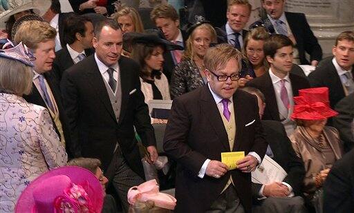 British singer Elton John and his partner David Furnish arrive at Westminster Abbey for the Royal Wedding in London.