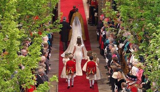 Kate Middleton walks down the aisle as she arrives at Westminster Abbey for the Royal Wedding in London .