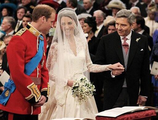 Prince William greets Kate Middleton as she arrives at the alter with her father Michael Middleton, prior to their marriage in London's Westminster Abbey.